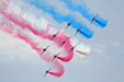 The Red Arrows formation with colored smoke on