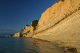 Setting sun light on the rocks of Logas beach in Corfu